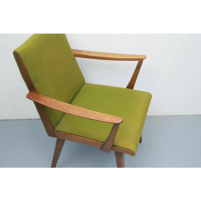 50s chair with armrests. Grazile elegant construction made of solid cherry wood. Original cover in a covered green....