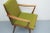 50s chair with armrests. Grazile elegant construction made of solid cherry wood. Original cover in a covered green....