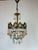 This single-light antique brass crystal chandelier dates back to the 1960s and features a rare bronze-toned brass body...