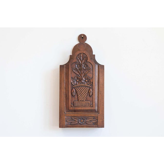 A French Provençale carved walnut farinerio decorative box from the 19th century with floral motifs. This petite French...