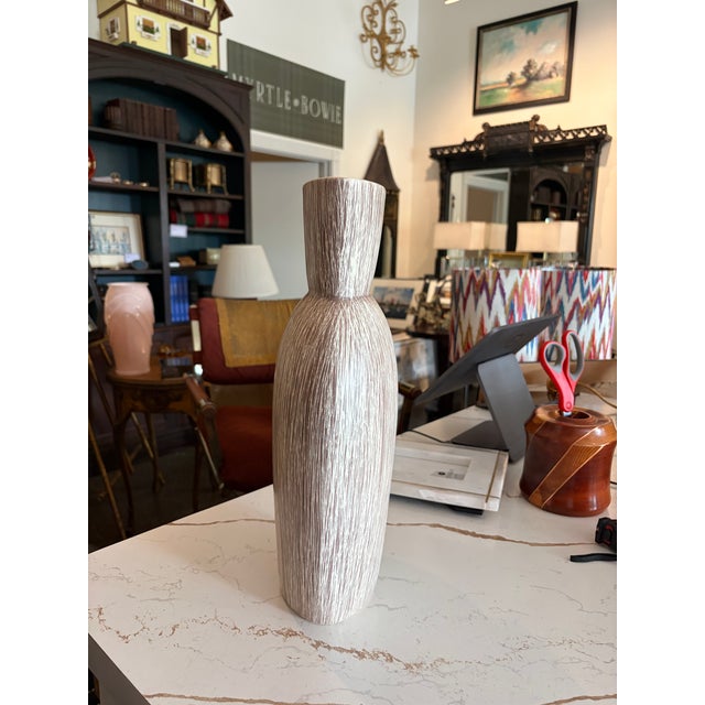 Large vintage Haeger ceramic vase with a sculptural hourglass silhouette and richly textured vertical striations in warm...