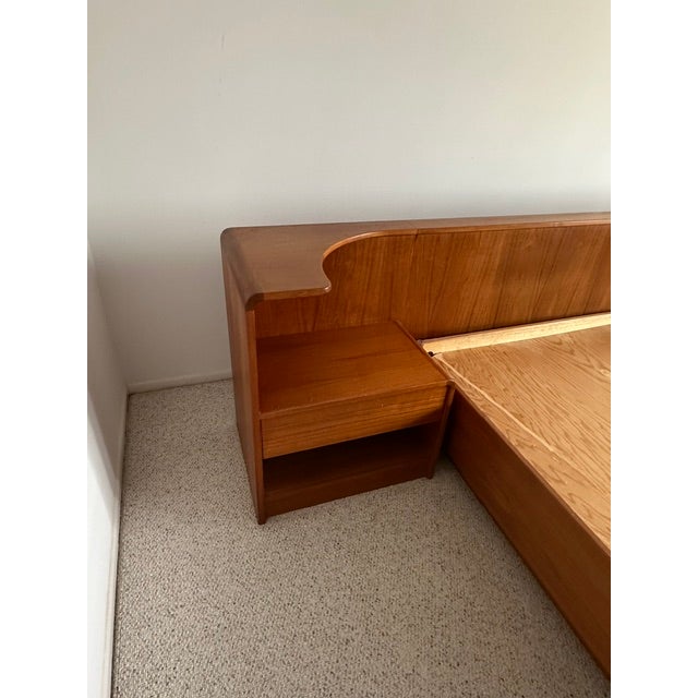 Mid-century modern teak integrated king size platform bedframe & headboard with rounded corners; storage drawers on left &...