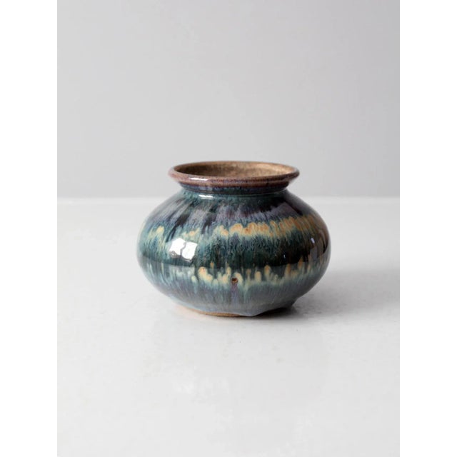 This is a vintage studio pottery vase. Signed by the artist, the bulbed handmade vase has a stunning fired glaze with rich...