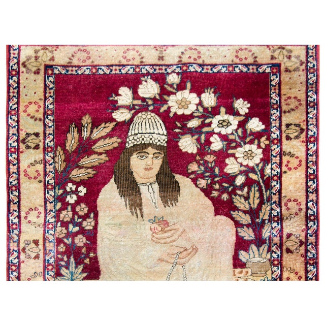 A stunning late 19th century Persian Lavar Kirman pictorial rug depicting a seated Gonabadi Dervish, a Sufi order...