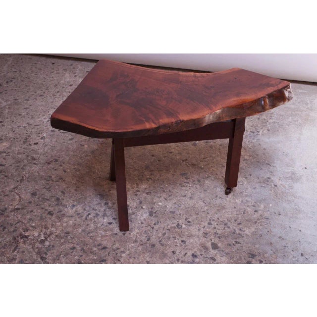 Expertly crafted circa 1950s walnut live edge side / occasional table with three-legged base. Additional details include 2...