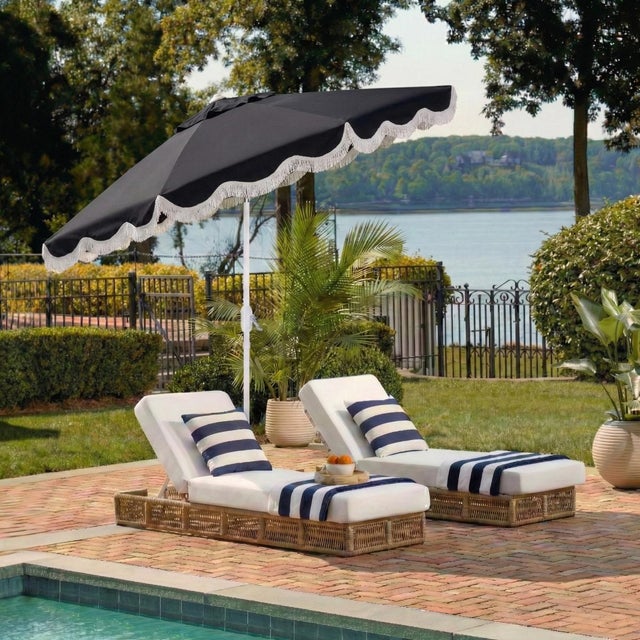 Transform your outdoor space into a stylish oasis with the Torsa 9 ft crank umbrella. Featuring a navy and white design,...