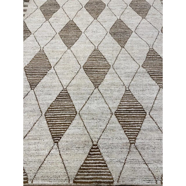 Hand-knotted Moroccan rug made with allover design rug is made of 75% wool & 25% cotton, dyed with pigment from the...