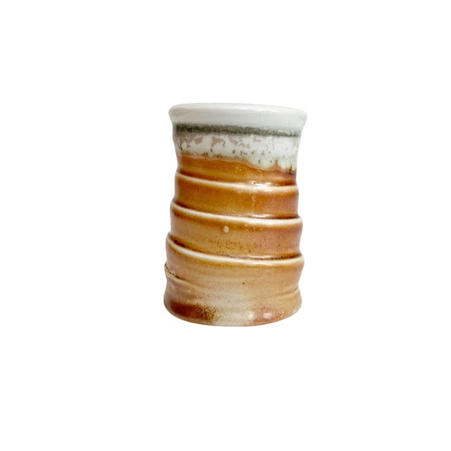 Elevate your home decor with our Artisan Stamped Wheel Thrown Pottery Bud Vase, featuring a unique textured spiral design...