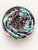 This striking 1990s American studio art glass vase features a vibrant, multi-colored frit swirl pattern encased in heavy,...