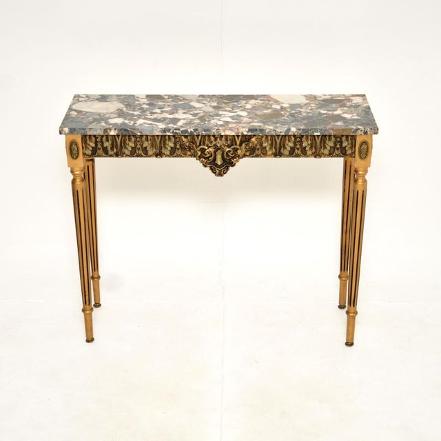 A beautiful antique French gilt wood marble top console table, dating from around the 1930’s. This has a stunning design,...