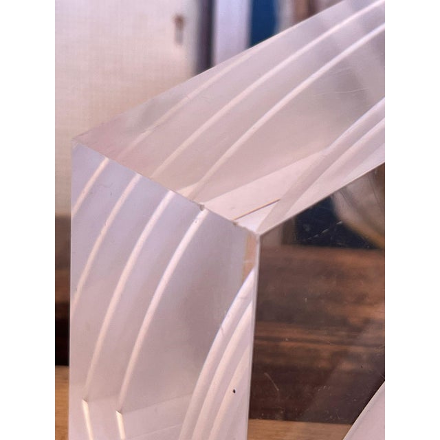 Single MCM Bookend of geometric style and lucite material. Chips and minor flaws consistent with a vintage piece. Vintage...