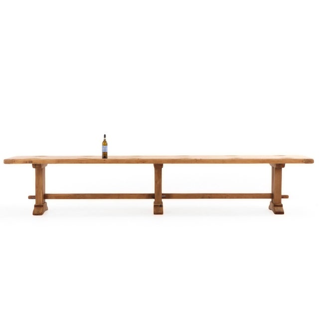An exceptional and highly unusual French solid oak triple-pedestal farmhouse table, dating to circa 1945. This remarkable...
