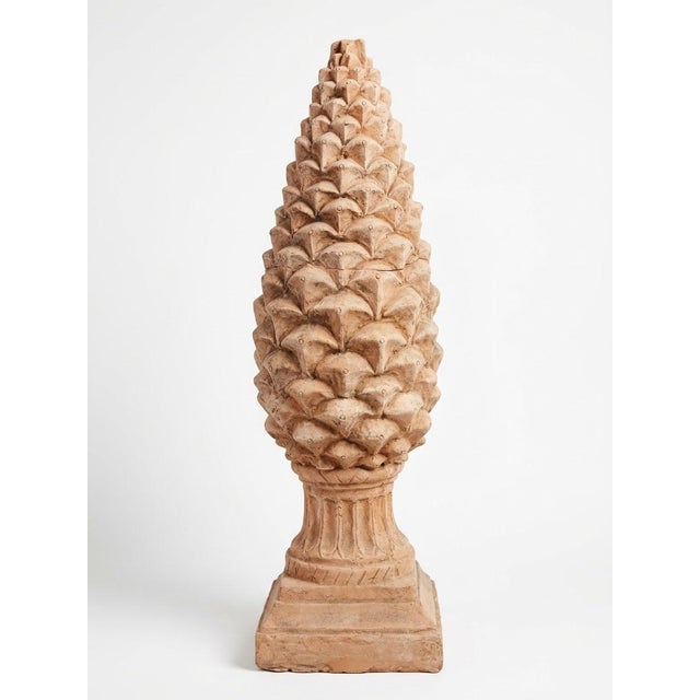 This grand vintage terracotta finial features a classic pinecone motif mounted on a fluted pedestal base with a square...