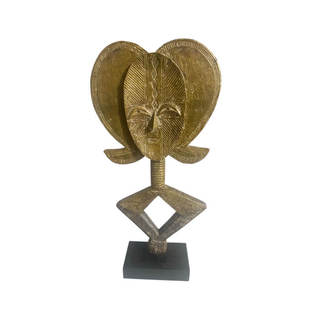 This exceptional Bakota reliquary figure from Gabon hand carved from a wooden armature sheathed in meticulously hammered...