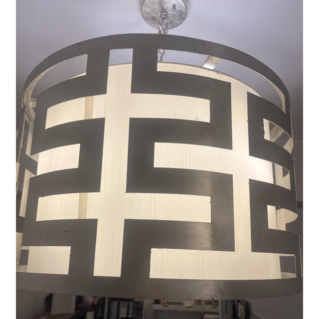 This large drum light is understated, but still noticeable. It's linen shade and frosted glass emits a soft light, while...