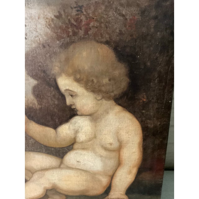 A charming 19th century European oil painting depicting the Christ Child with the infant Saint John the Baptist and the...