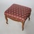An antique French style footstool offers upholstered seat over walnut base having carved skirt and cabriole legs, C1920....