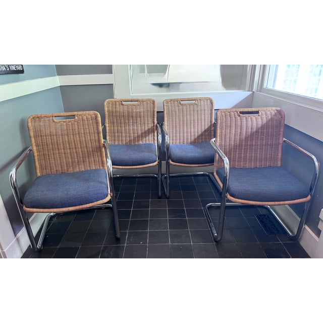 Harvey Probber style attributed to Chromcraft. Wicker and chrome dining chairs - Set of 4. Features a wicker backrest and...