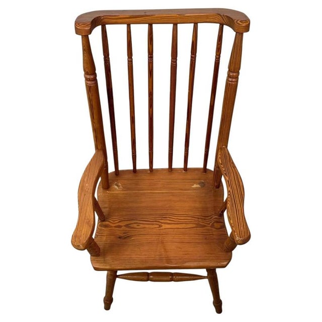 A beautifully crafted 20th-century stick back armchair, constructed in pitch pine and combining traditional country...