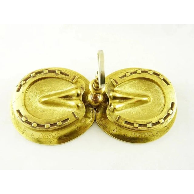 A 19th C brass figural inkwell in the form of two horses hooves with shoes. Quite large in size with fine details. One...