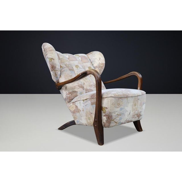Architectural and highly sculptural wingback lounge chair produced in Prague, Czech Republic, circa 1920s–1930s,...