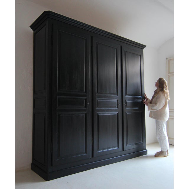 Exceptionally large vintage wardrobe, disassembled into a wardrobe, with three doors. Solid softwood construction with an...