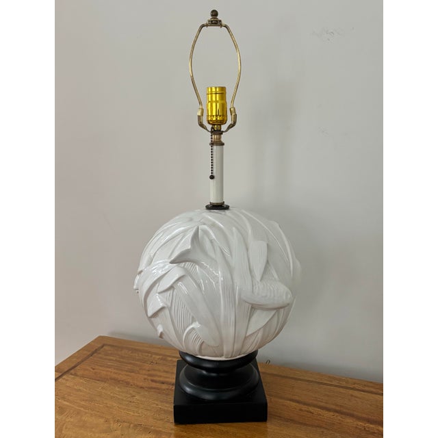 Large Midcentury round ceramic table lamp on a dark squared base. Features koi fish and vegetation in relief. Striking...