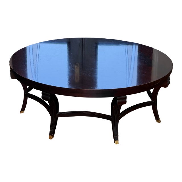 Attributed to Hickory Chair Company Flame Mahogany Round Coffee Table With Brass Sabots For Sale