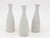 Each single white ceramic vase, crafted in early 21st century France, is part of a set of three, with multiple sets...