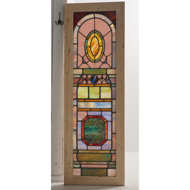 Set of matching Gothic rare antique stained glass windows. The panels feature multi colored geometric patterns, including...