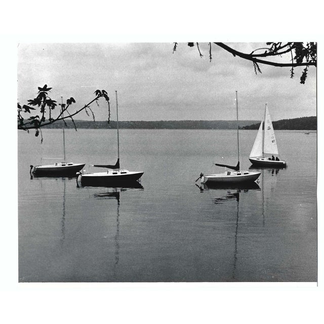 May 1972 black and white photograph of sailboats in Lake Washington moored off the shore in Kirkland. Publication...