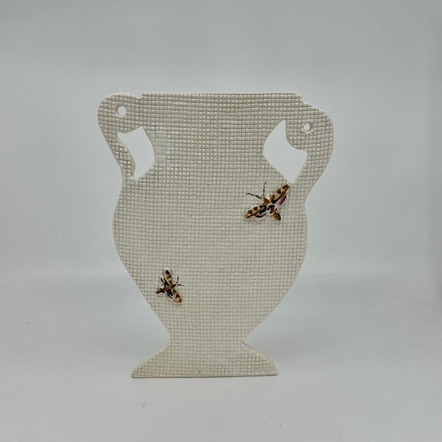 Handmade ceramic Silhouette vase with sculpted hand painted moths. These silhouette vases are shallow enough to sit on a...