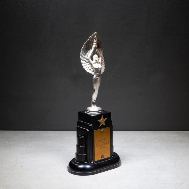 ABOUT An original Art Deco trophy with a Bakelite base, brass star and topped with a winged woman. Brass plate inscribed...