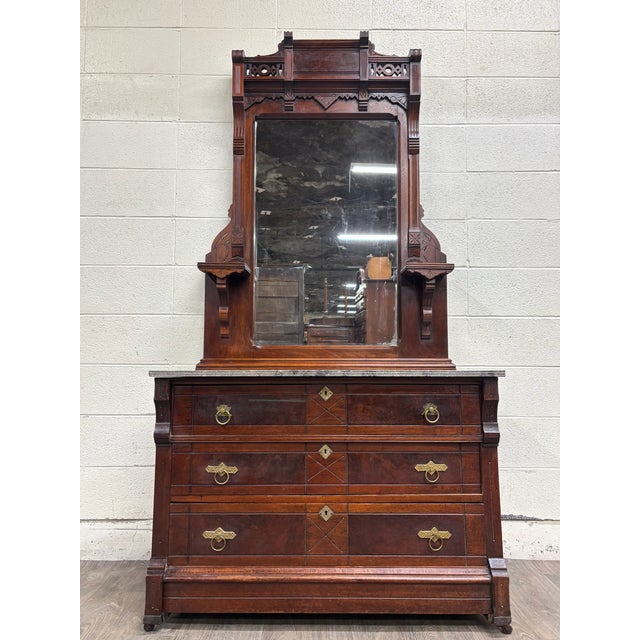 This is a stunning antique Victorian Eastlake marble top dresser, chest, or dressing stand dating to the late 19th...