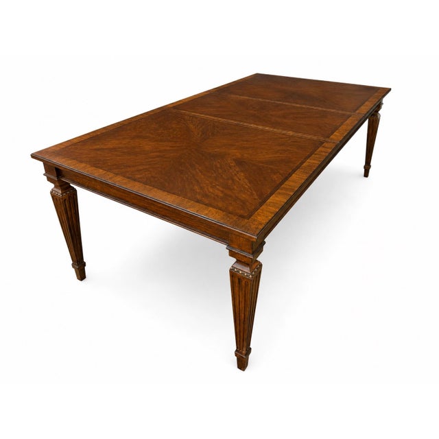 A handsome and substantial Ethan Allen dining set includes a rectangular dining table featuring a beautifully grained top...