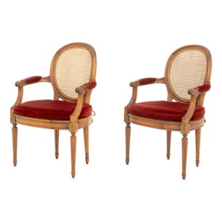 Pair of Louis XVI Style Red Velvet Upholstered Cane Paneled Walnut Fauteuils For Sale
