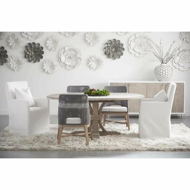 This solid acacia wood round extendable dining table offers flexible seating for intimate family meals and larger...