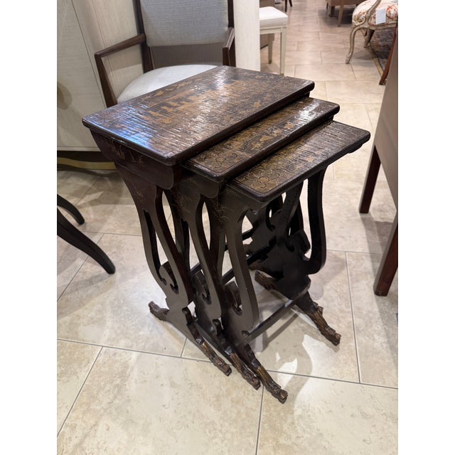 Elegant and Stately set of Chinoiserie nesting tables with a wonderfully aged Patina of black and gold coromandel hand...