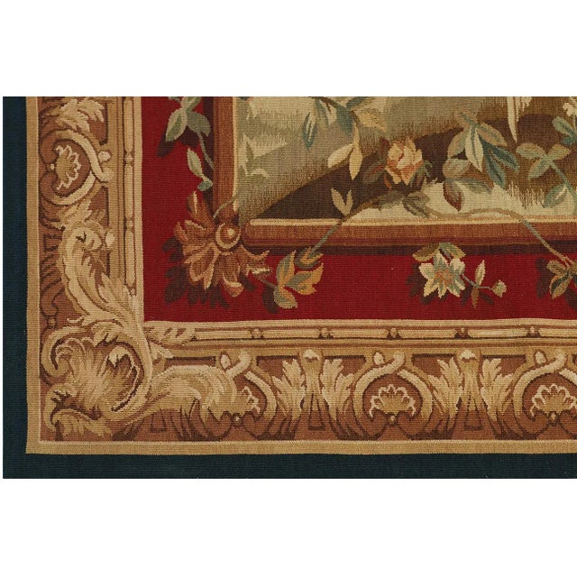 This beautiful horizontal Aubusson tapestry depicts a scene in which a young male is seen picking grapes as two females...