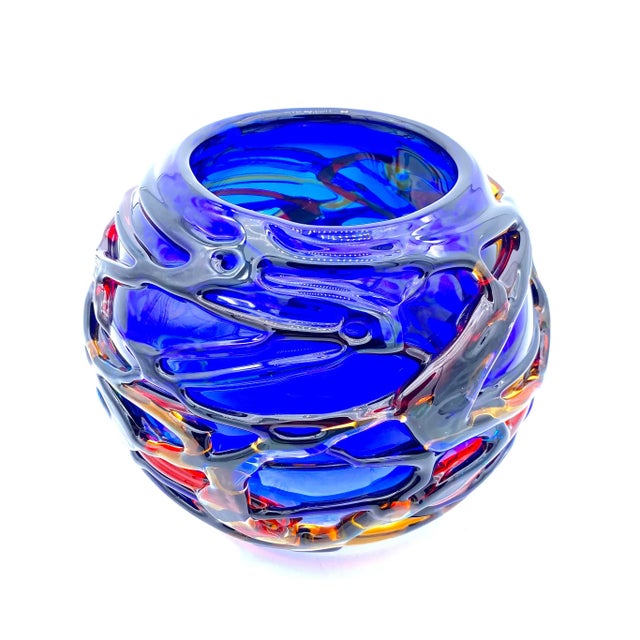 Artistic spherical Murano glass vase with an intense blue colour. Sinuous shape and colors inspired by the sea make this...