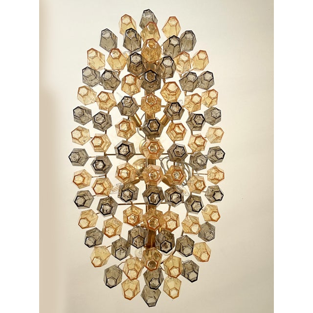 Italian oval hand- made chandelier in a bath of gold 24k metal frame brushed . Amber and fumè color of “poliedri” elements...