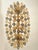 Italian oval hand- made chandelier in a bath of gold 24k metal frame brushed . Amber and fumè color of “poliedri” elements...