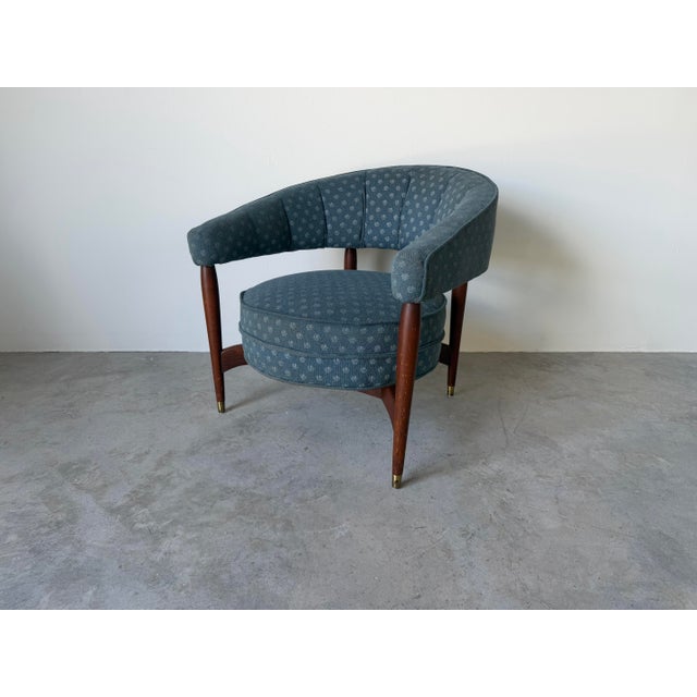 Stylish 1960s Mid-Century Modern barrel lounge chair featuring a distinctive “floating” design with a sculptural curved...