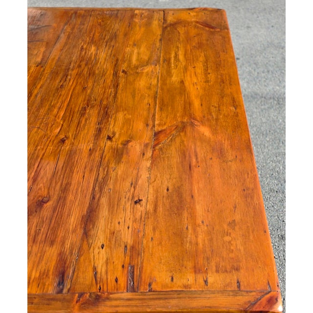 A rare and exceptionally characterful early American vernacular farmhouse dining table, dating to circa 1800, crafted in...