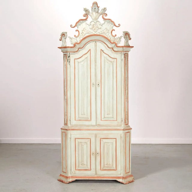 Early 20th Century Painted Baroque Cabinet in Two Parts. Arched pediment with large scroll crest, paneled doors opening to...