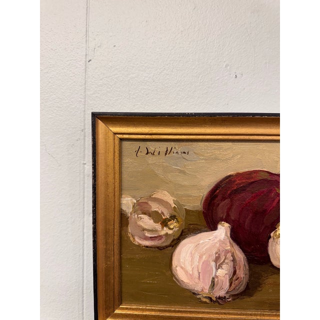 This 20th Century oil on canvas still life depicts garlic bulbs and beet rendered in warm, earthy tones with expressive...