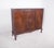 Sideboard with three doors. In dark wood, with shelves inside, it has a sturdy, symmetrical structure, with three front...