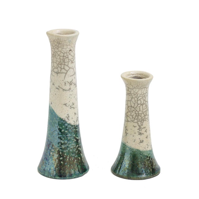 Two candle holders with a stunning raku crackle' effect on the top and cut at the bottom by a "wave" of green metal color...