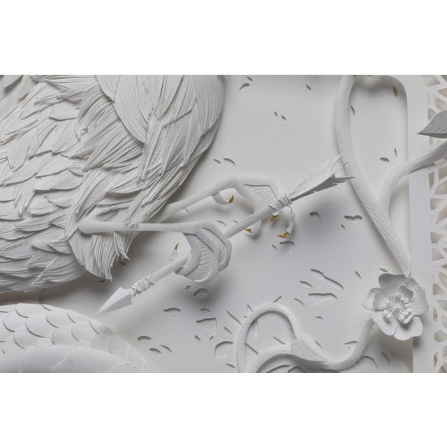 This paper sculpture intricately depicts a majestic bird, its wings outstretched in a dynamic pose, symbolizing freedom...