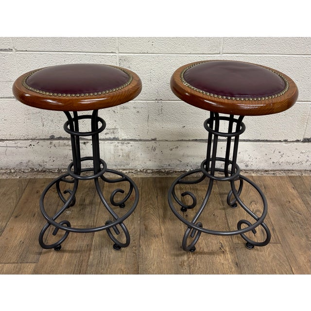 This is a gorgeous pair of vintage Virginia House oxblood or burgundy vinyl and nail head swivel backless bar stools or...